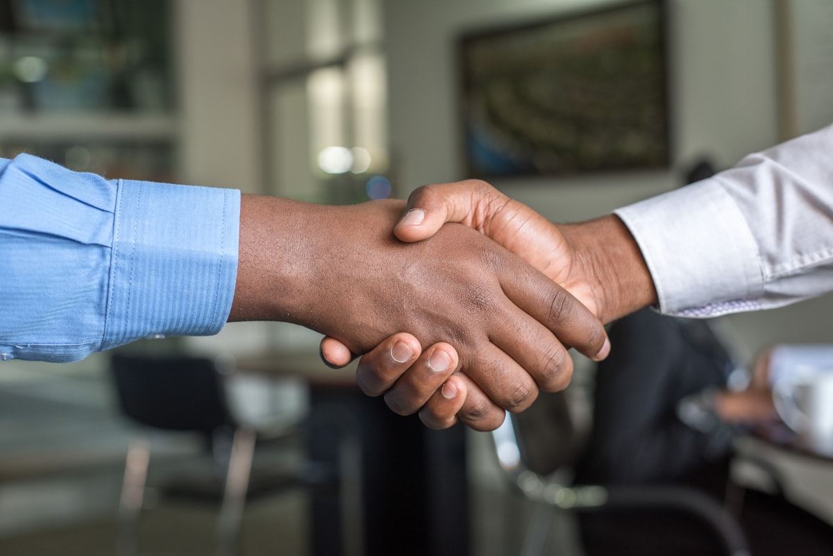 Professional handshake across an office desk